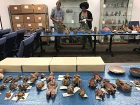 Kendyll Gross works to curate the new exhibit at the Blanton Museum. Masters student Kendyll Gross curating artifacts.